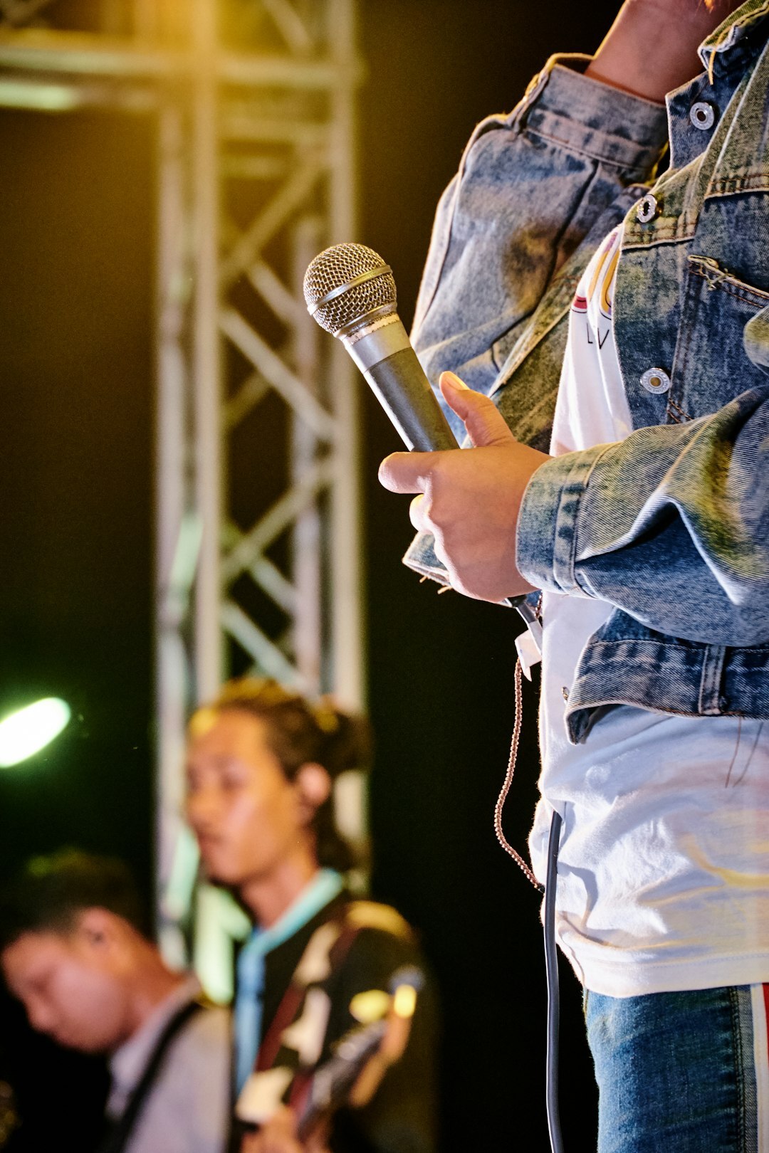 Close up of a female speaker holding a microphone on stage