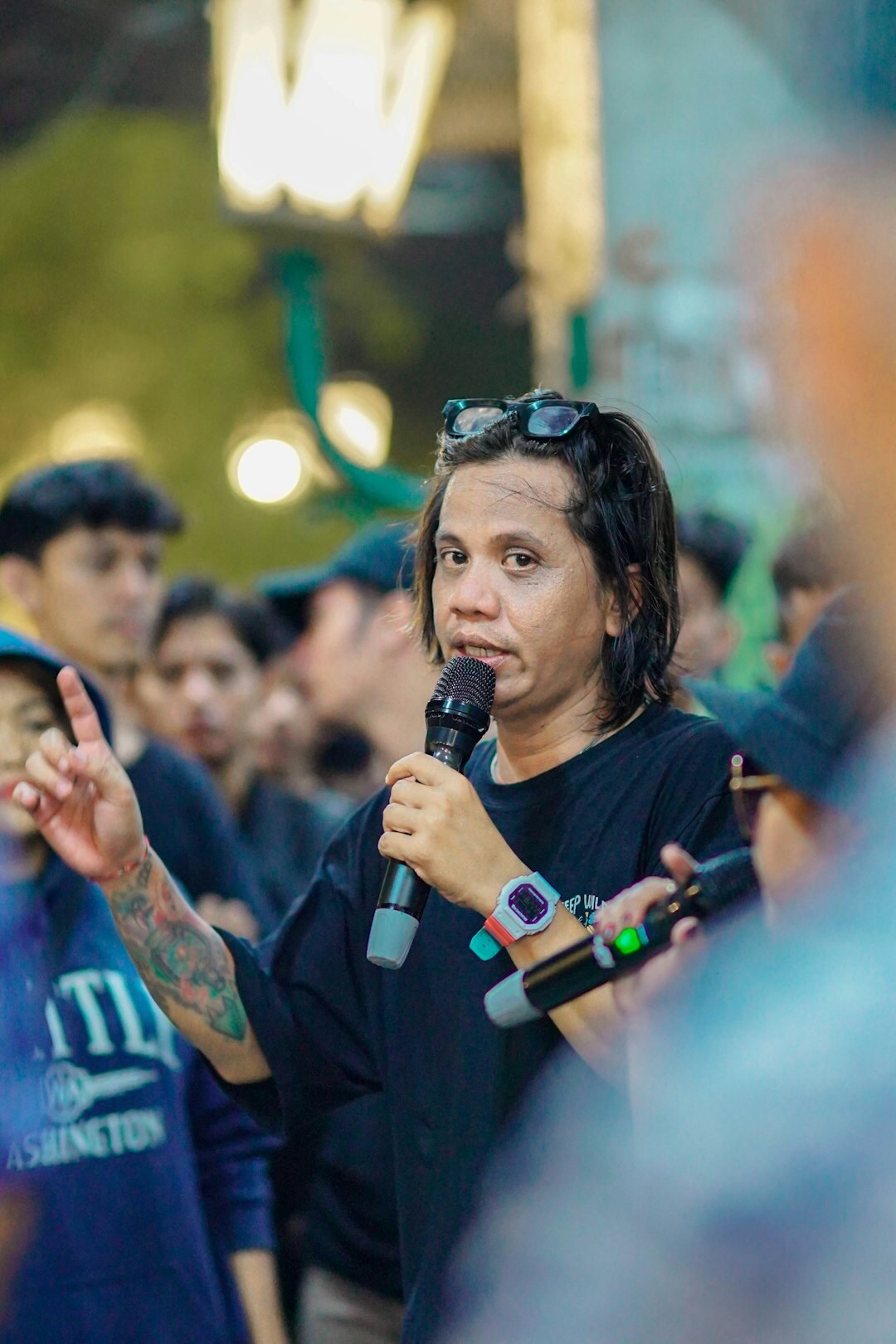 Moderator engaging with festival crowd holding a microphone